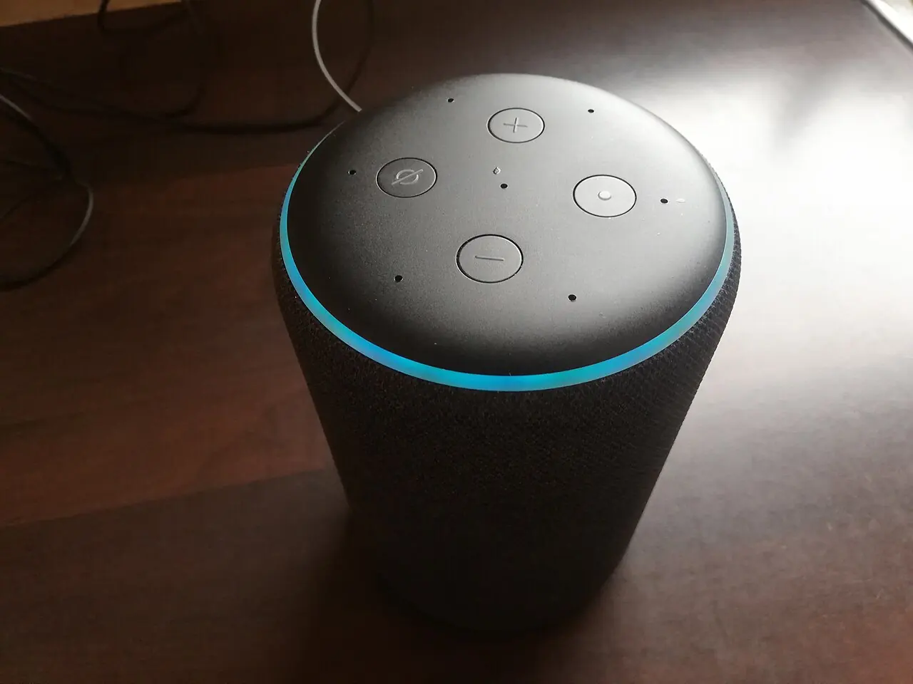 Amazon Echo smart speaker with its blue light ring glowing