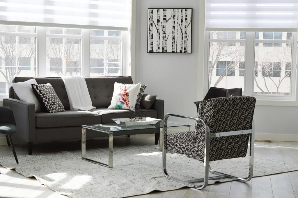 Furnished living room with a gray sofa and large windows